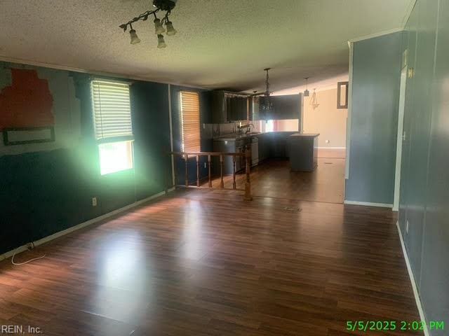 105 Chambliss Rd, Emporia, VA 23847 - unfurnished living room with wood finished floors, a textured ceiling, and baseboards