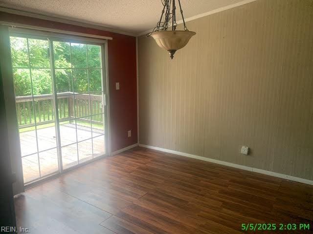 105 Chambliss Rd, Emporia, VA 23847 - unfurnished dining area with dark wood-type flooring, baseboards, and a textured ceiling