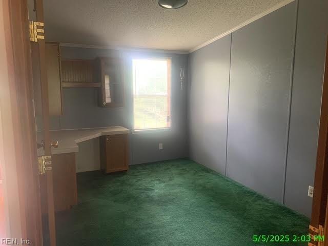 105 Chambliss Rd, Emporia, VA 23847 - unfurnished dining area featuring crown molding, a textured ceiling, light carpet, and an office area