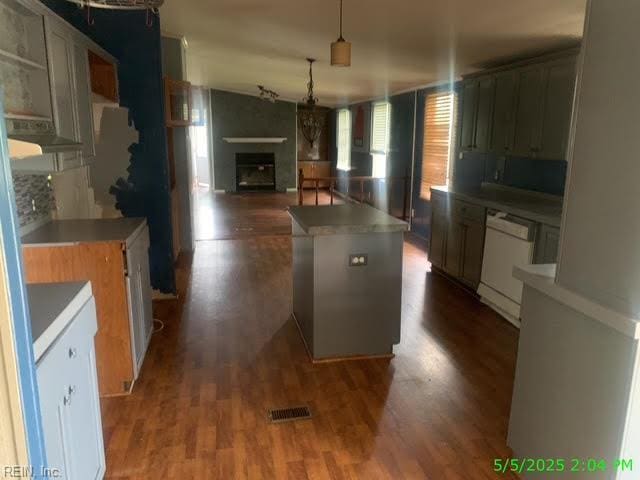 105 Chambliss Rd, Emporia, VA 23847 - kitchen with white dishwasher, dark wood-style flooring, a fireplace, and hanging light fixtures