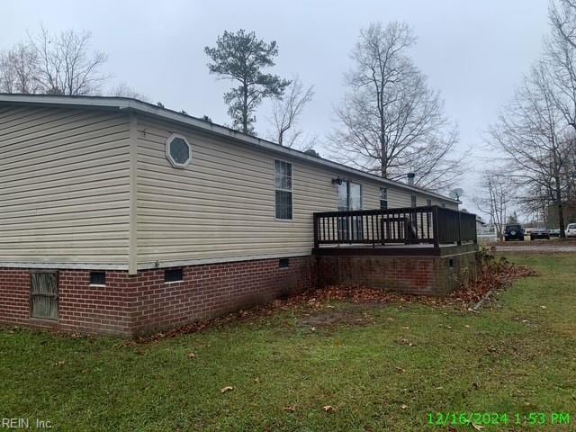 view of property exterior featuring a yard and a deck