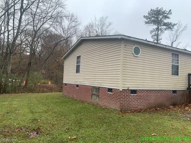 view of side of home featuring a lawn