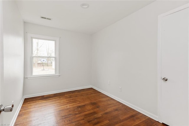 unfurnished room with dark hardwood / wood-style flooring