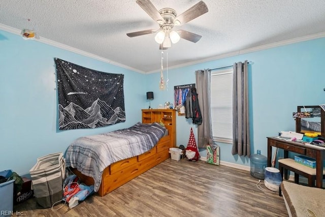 bedroom with a textured ceiling, hardwood / wood-style flooring, ceiling fan, and crown molding