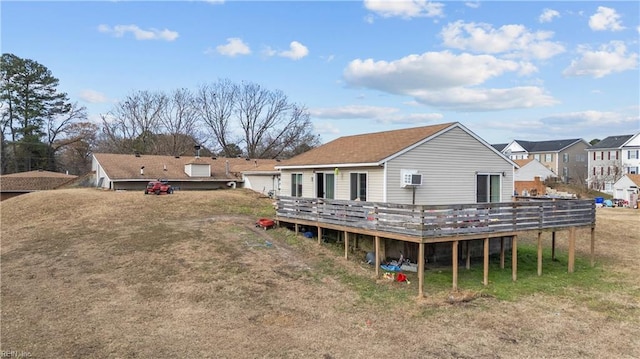 rear view of house featuring a wooden deck