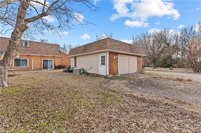 exterior space with a garage and an outdoor structure