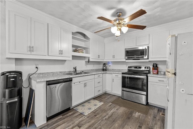 kitchen with white cabinetry, sink, stainless steel appliances, dark hardwood / wood-style floors, and ornamental molding