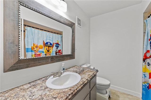 bathroom featuring tile patterned flooring, vanity, toilet, and curtained shower