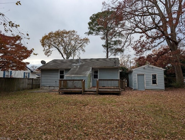 rear view of house featuring a shed, a deck, and a yard