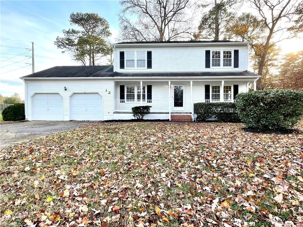 front of property with a porch and a garage