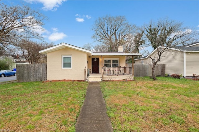 ranch-style house with a porch and a front lawn