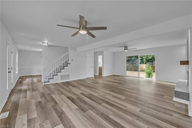 unfurnished living room with light hardwood / wood-style flooring and ceiling fan