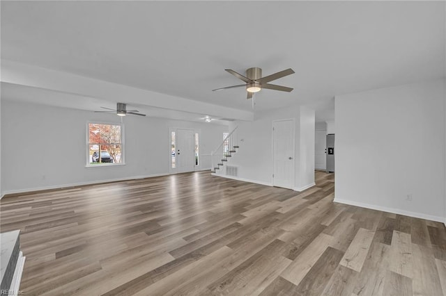 unfurnished living room with ceiling fan and light hardwood / wood-style flooring