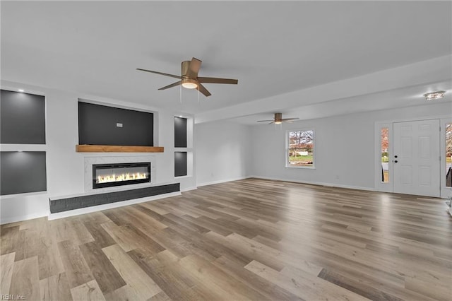 unfurnished living room with ceiling fan and light hardwood / wood-style floors