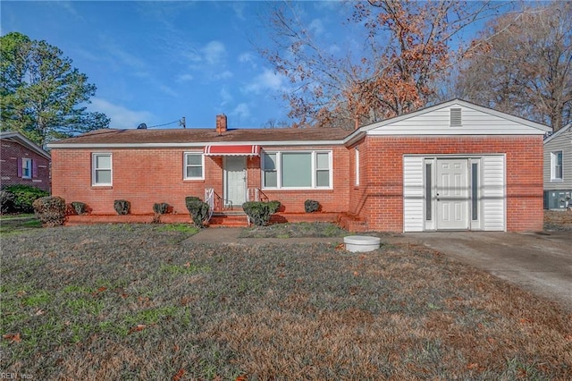 ranch-style house featuring central AC unit and a front yard