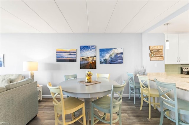 dining area with dark hardwood / wood-style flooring