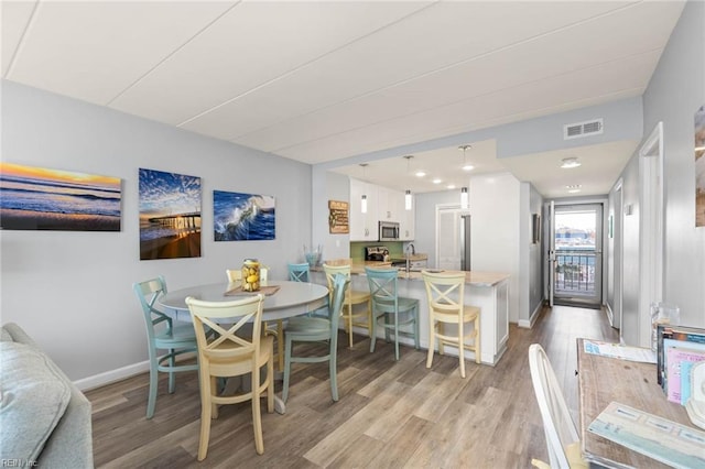 dining room with light hardwood / wood-style floors and sink