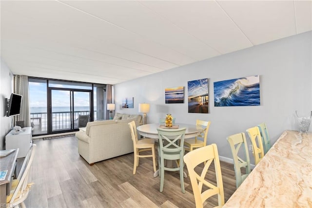 dining area featuring floor to ceiling windows and light hardwood / wood-style floors