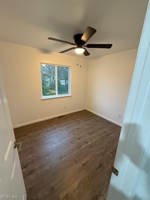 unfurnished room with ceiling fan and dark wood-type flooring