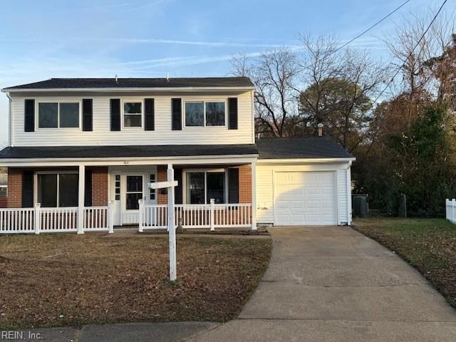 front of property with covered porch and a garage