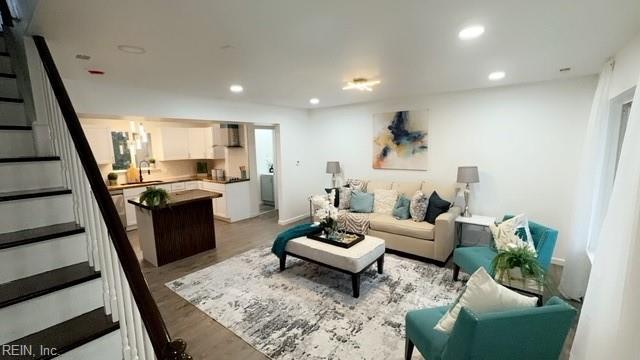 living room featuring sink and wood-type flooring