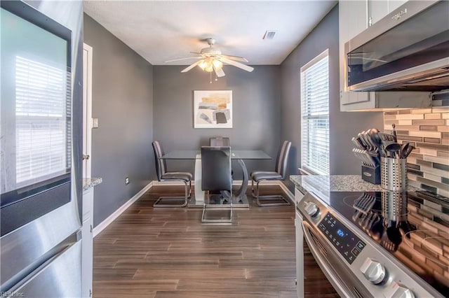 dining room featuring ceiling fan and dark hardwood / wood-style floors