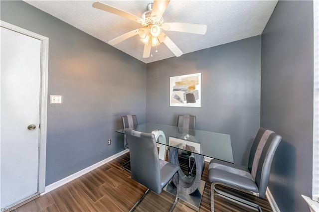 dining room featuring hardwood / wood-style flooring, ceiling fan, and a textured ceiling