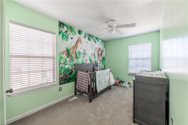 bedroom with light colored carpet and ceiling fan