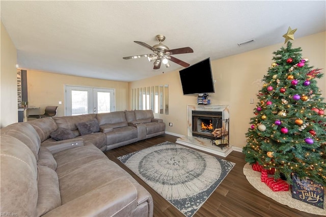 living room with dark hardwood / wood-style flooring, ceiling fan, and french doors