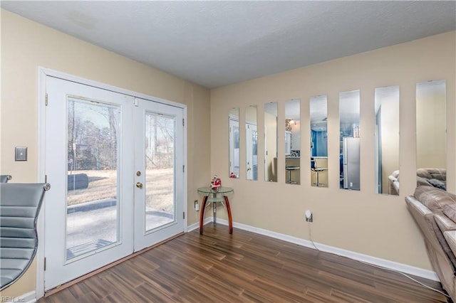 entryway with dark hardwood / wood-style floors and french doors