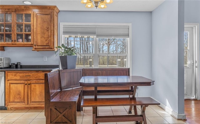 dining room featuring a notable chandelier and light tile patterned flooring