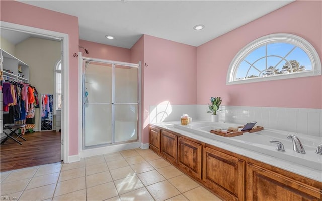 bathroom with tile patterned flooring and separate shower and tub