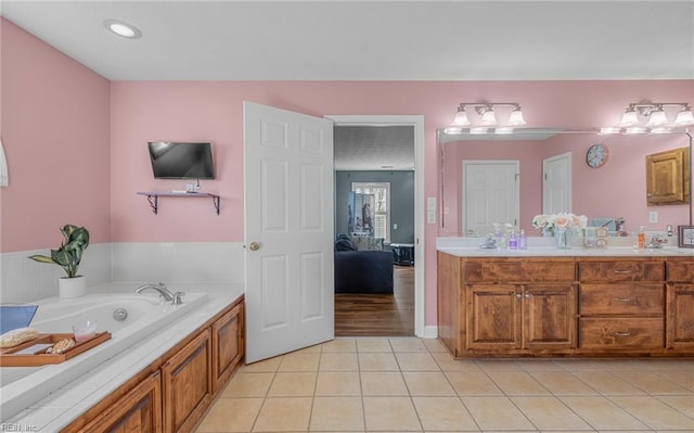 bathroom featuring tile patterned flooring, vanity, and a bathing tub