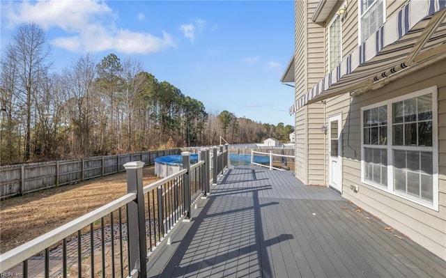 deck featuring a covered pool