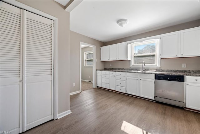 kitchen featuring white cabinetry, dishwasher, light hardwood / wood-style floors, and sink