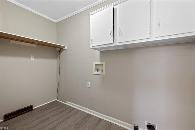 clothes washing area with cabinets, electric dryer hookup, dark hardwood / wood-style floors, crown molding, and hookup for a washing machine