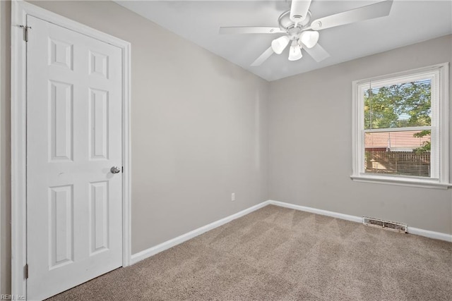 empty room with carpet flooring and ceiling fan