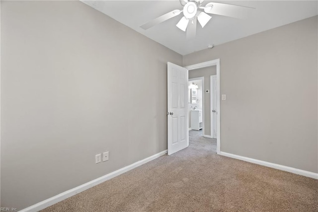 spare room with ceiling fan and light carpet