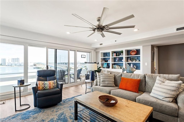 living room with wood-type flooring and ceiling fan