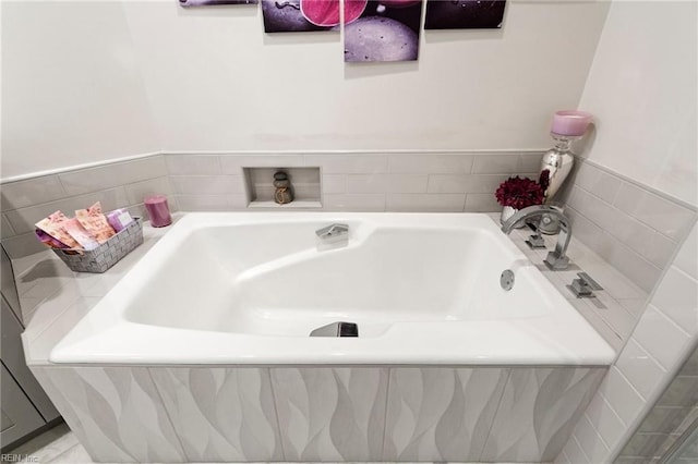 bathroom featuring a relaxing tiled tub