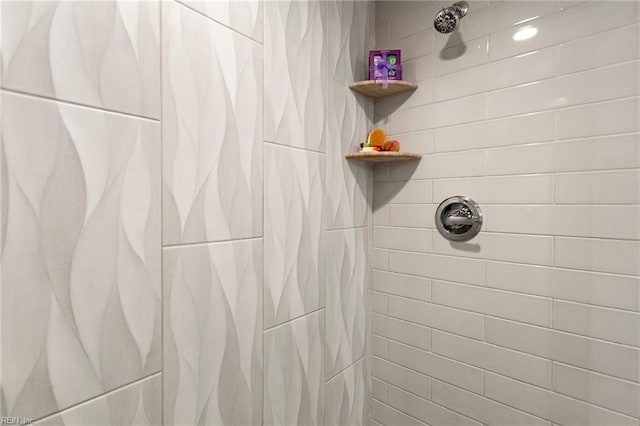 interior details featuring tiled shower