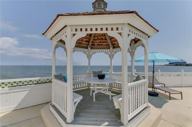 exterior space with a view of the beach, a gazebo, and a water view