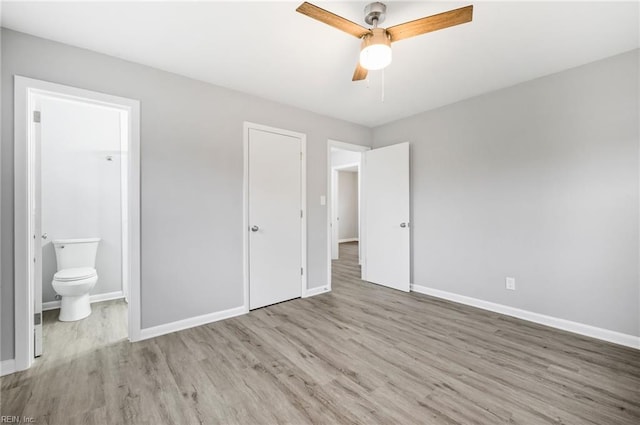 unfurnished bedroom featuring light hardwood / wood-style floors, ceiling fan, and ensuite bathroom