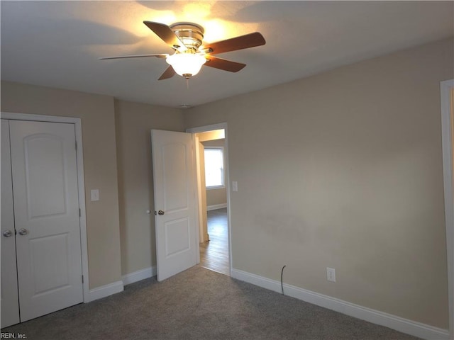 unfurnished bedroom featuring ceiling fan, a closet, and carpet