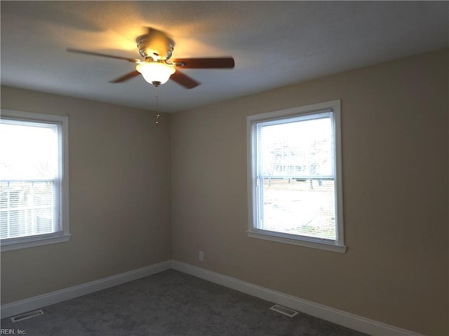 carpeted spare room with ceiling fan