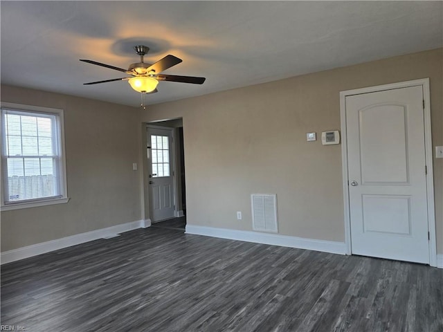 empty room featuring dark hardwood / wood-style floors and ceiling fan