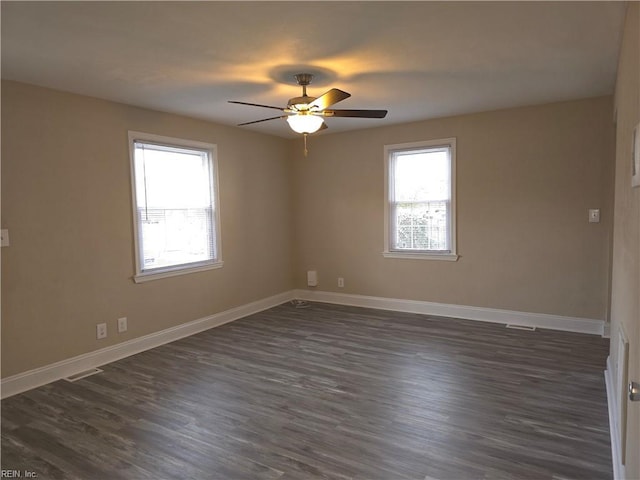 spare room with ceiling fan and dark hardwood / wood-style flooring