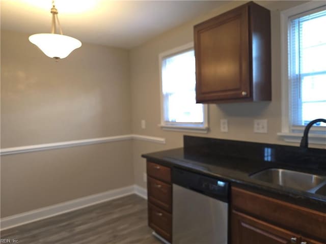 kitchen featuring dark hardwood / wood-style flooring, decorative light fixtures, stainless steel dishwasher, and sink