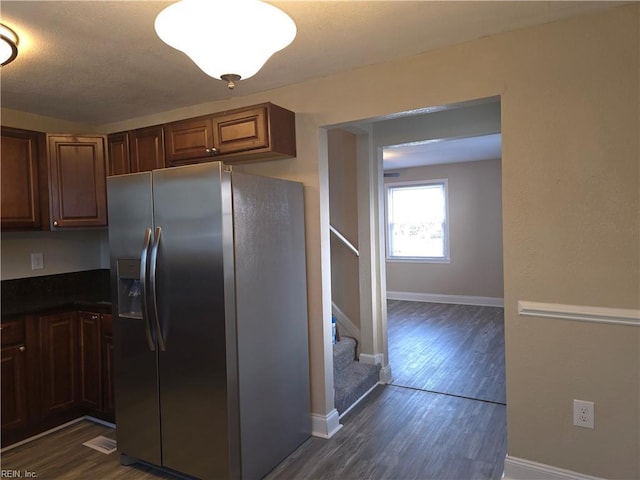 kitchen featuring dark hardwood / wood-style floors and stainless steel refrigerator with ice dispenser