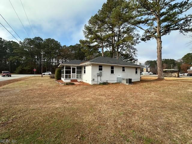 rear view of property with central AC